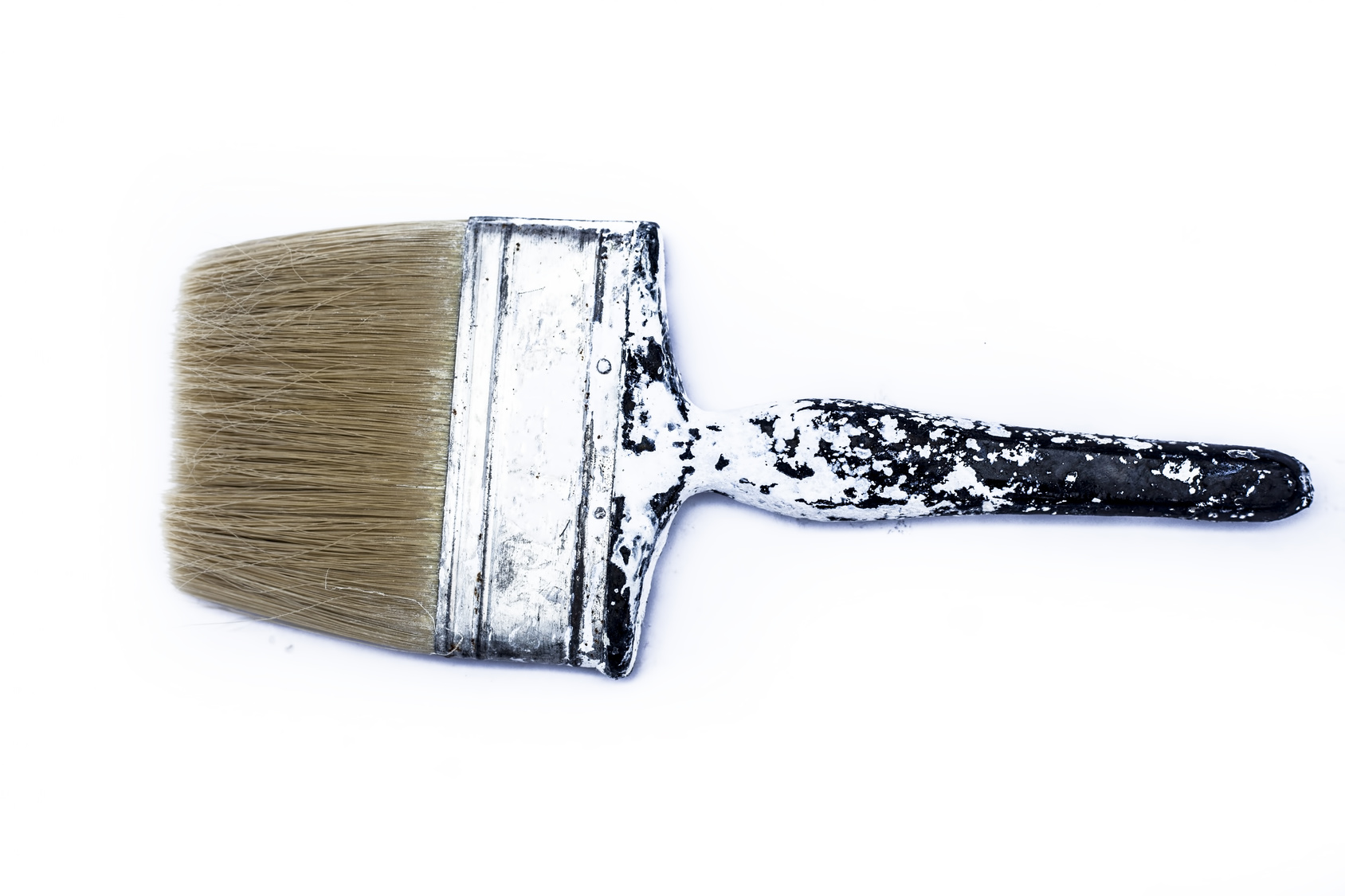 old paintbrush with white paint on 